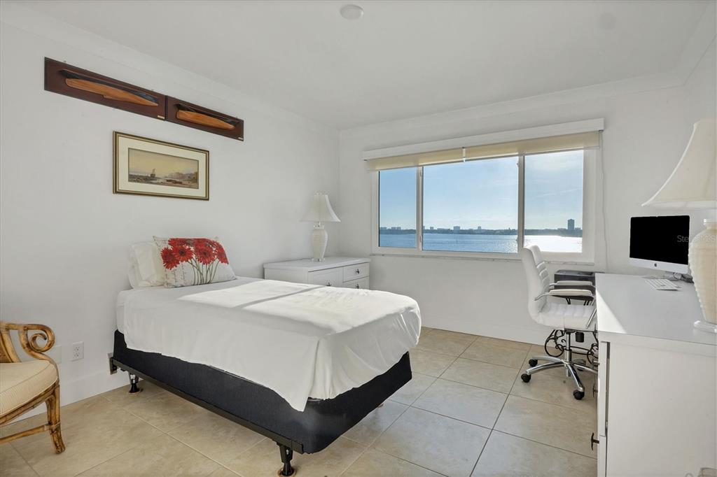 350 Golden Gate Point, Unit 62 Sarasota, FL 34236 - Photo 28 of 40 a bedroom with a bed and a desk
