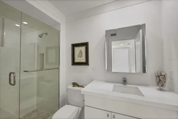 a bathroom with a sink toilet and shower