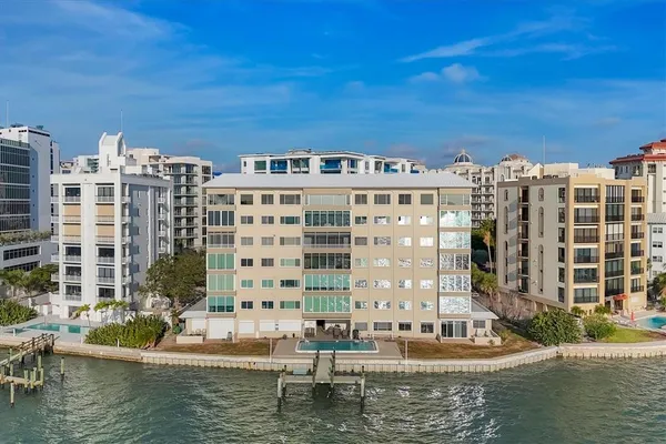 a front view of building with lake view and boat