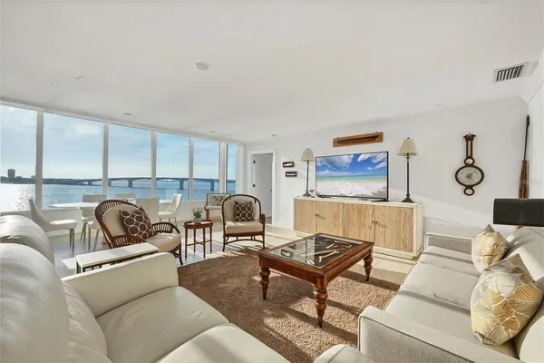 a living room with furniture a rug and white walls