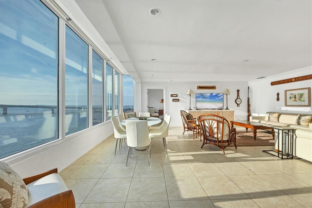350 Golden Gate Point, Unit 62 Sarasota, FL 34236 - Photo 9 of 40 a dining room with furniture and a floor to ceiling window