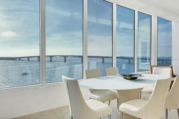 a dining room with a large window and table