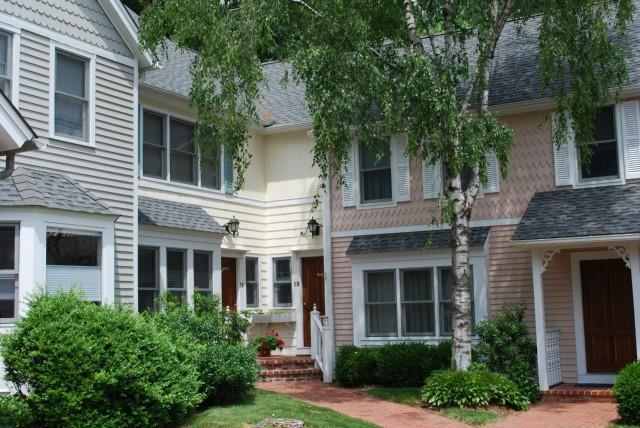 36 Catoonah Street, Unit 13 Ridgefield, CT 06877 - Photo 1 of 1 a front view of a house with plants and garden