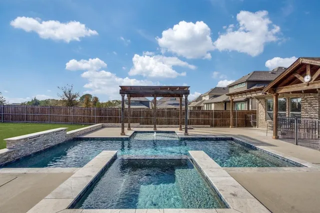 a view of a house with swimming pool and sitting area