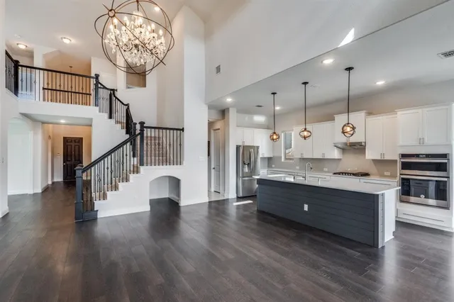 a view of entryway and kitchen with wooden floor