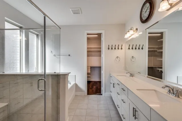 a spacious bathroom with a double vanity sink and a mirror