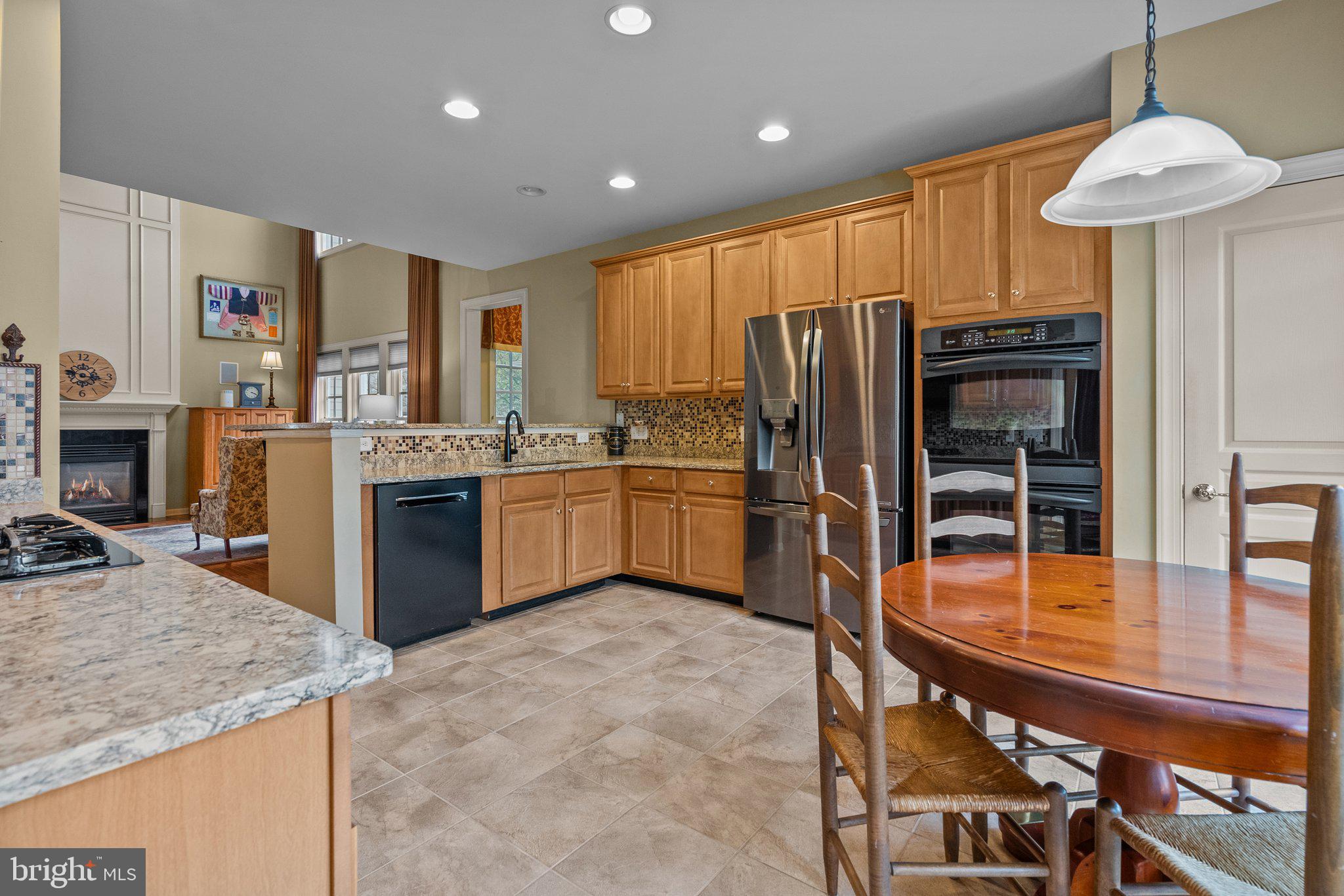 1606 Reading Circle Huntingdon Valley, PA 19006 - Photo 12 of 41 a kitchen with stainless steel appliances granite countertop a stove refrigerator sink and dishwasher with wooden floor