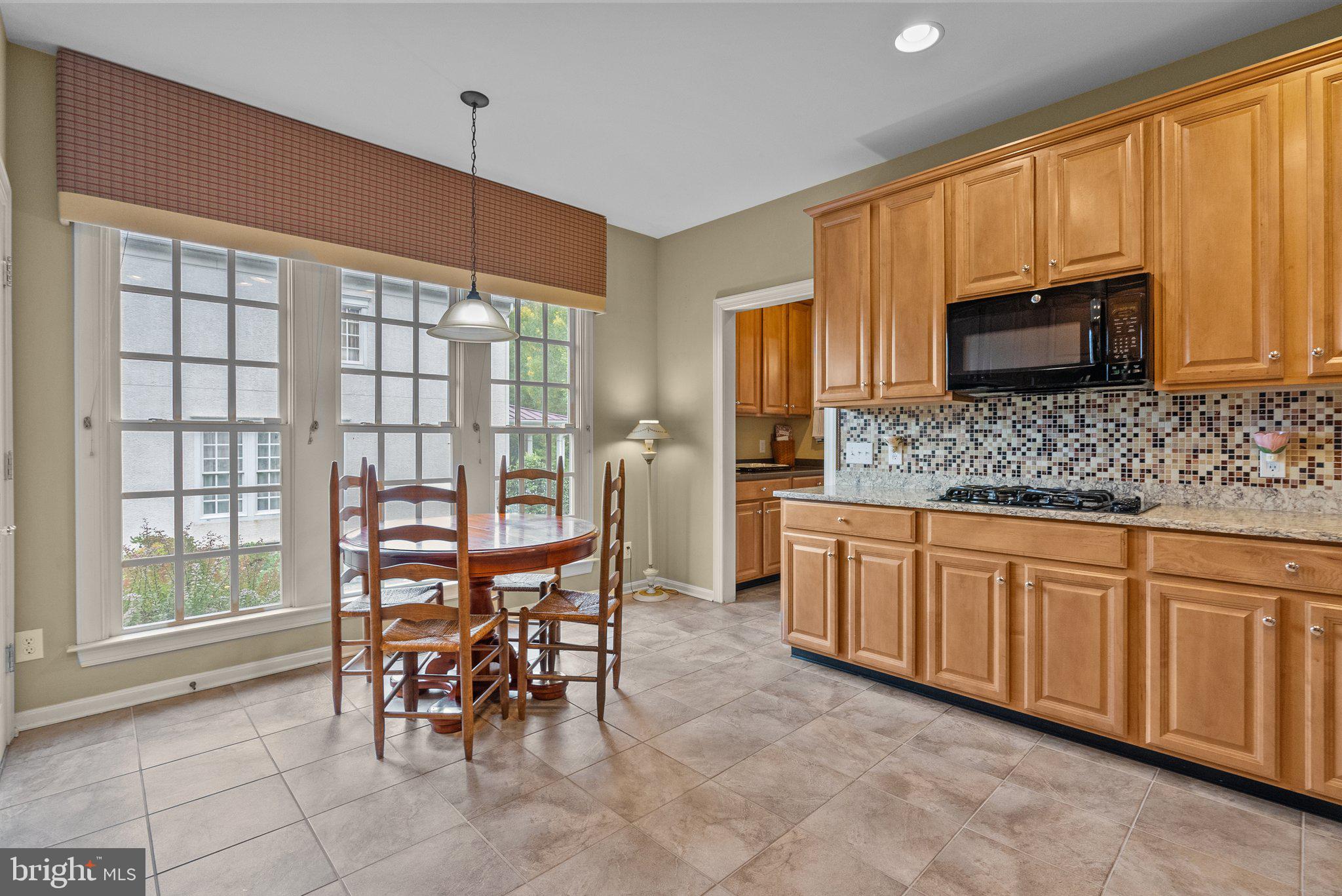1606 Reading Circle Huntingdon Valley, PA 19006 - Photo 15 of 41 a kitchen with stainless steel appliances granite countertop a stove a sink a microwave and a dining table