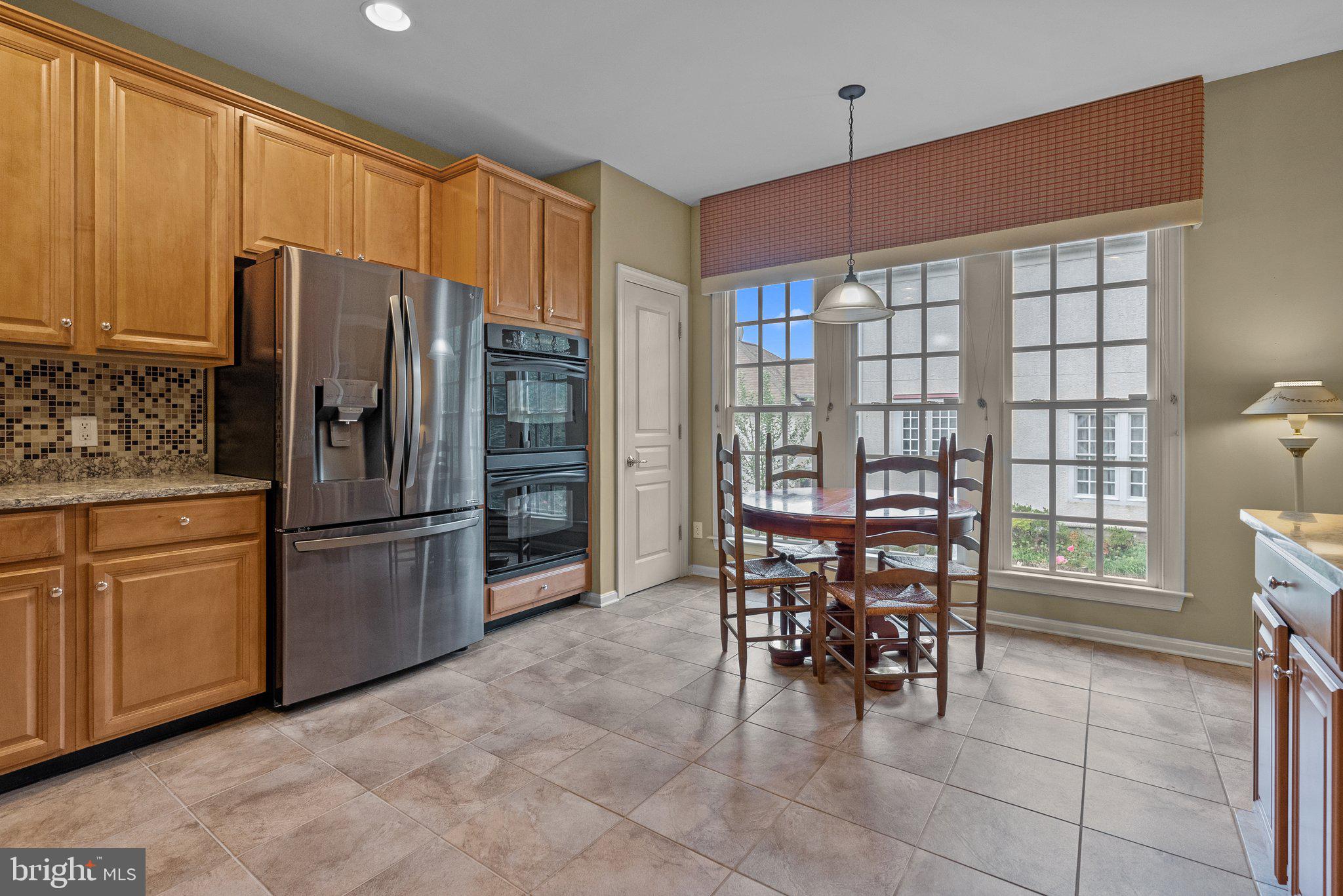 1606 Reading Circle Huntingdon Valley, PA 19006 - Photo 16 of 41 a kitchen with stainless steel appliances a refrigerator and wooden cabinets