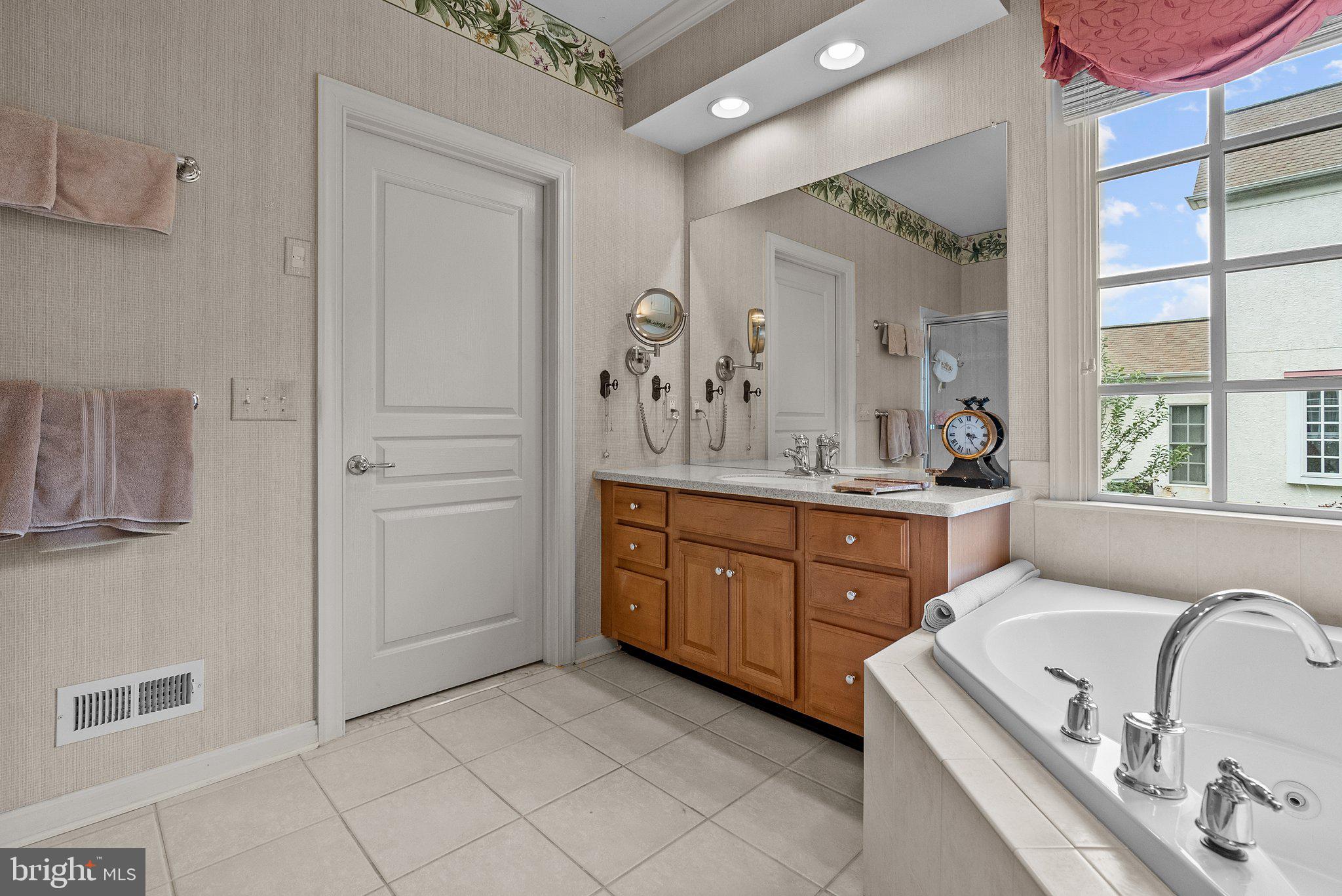 1606 Reading Circle Huntingdon Valley, PA 19006 - Photo 36 of 41 a spacious bathroom with a granite countertop sink and a mirror
