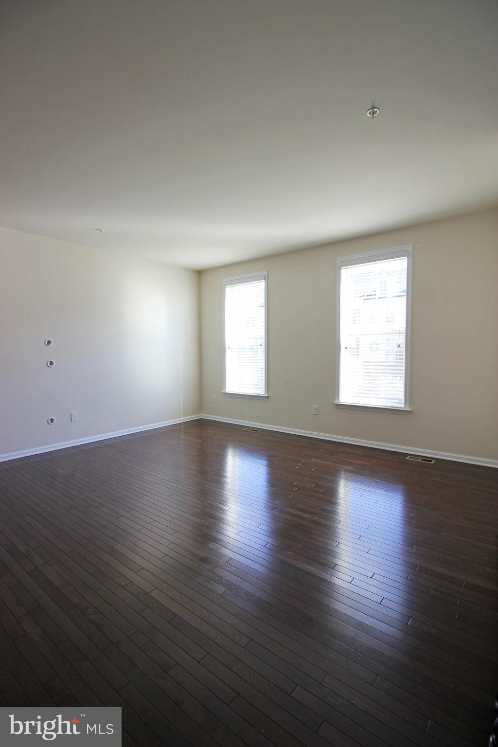 4720 Cambria Road Frederick, MD 21703 - Photo 2 of 41 an empty room with wooden floor and windows
