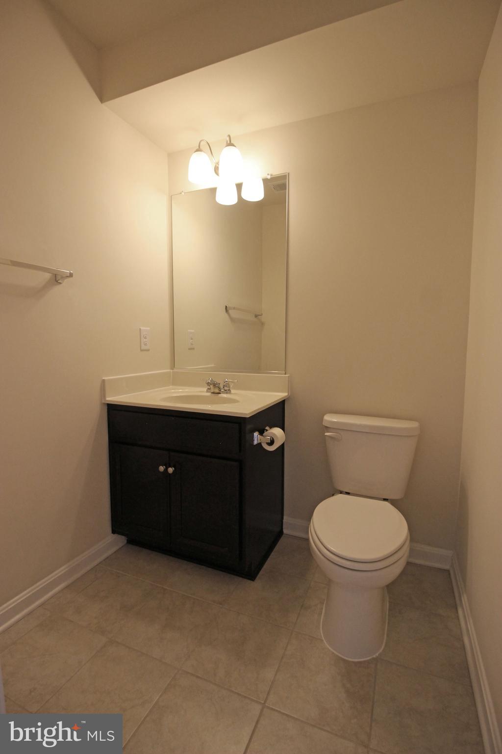 4720 Cambria Road Frederick, MD 21703 - Photo 33 of 41 a bathroom with a toilet sink and mirror