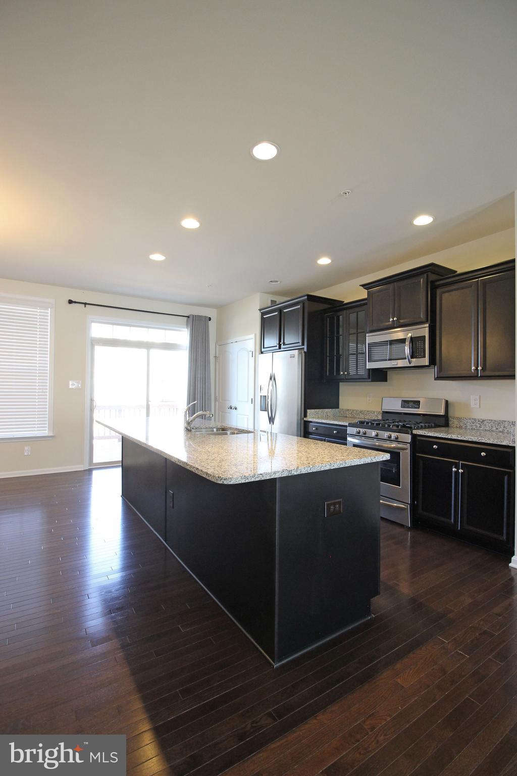 4720 Cambria Road Frederick, MD 21703 - Photo 7 of 41 a large kitchen with stainless steel appliances granite countertop a large counter top and a stove