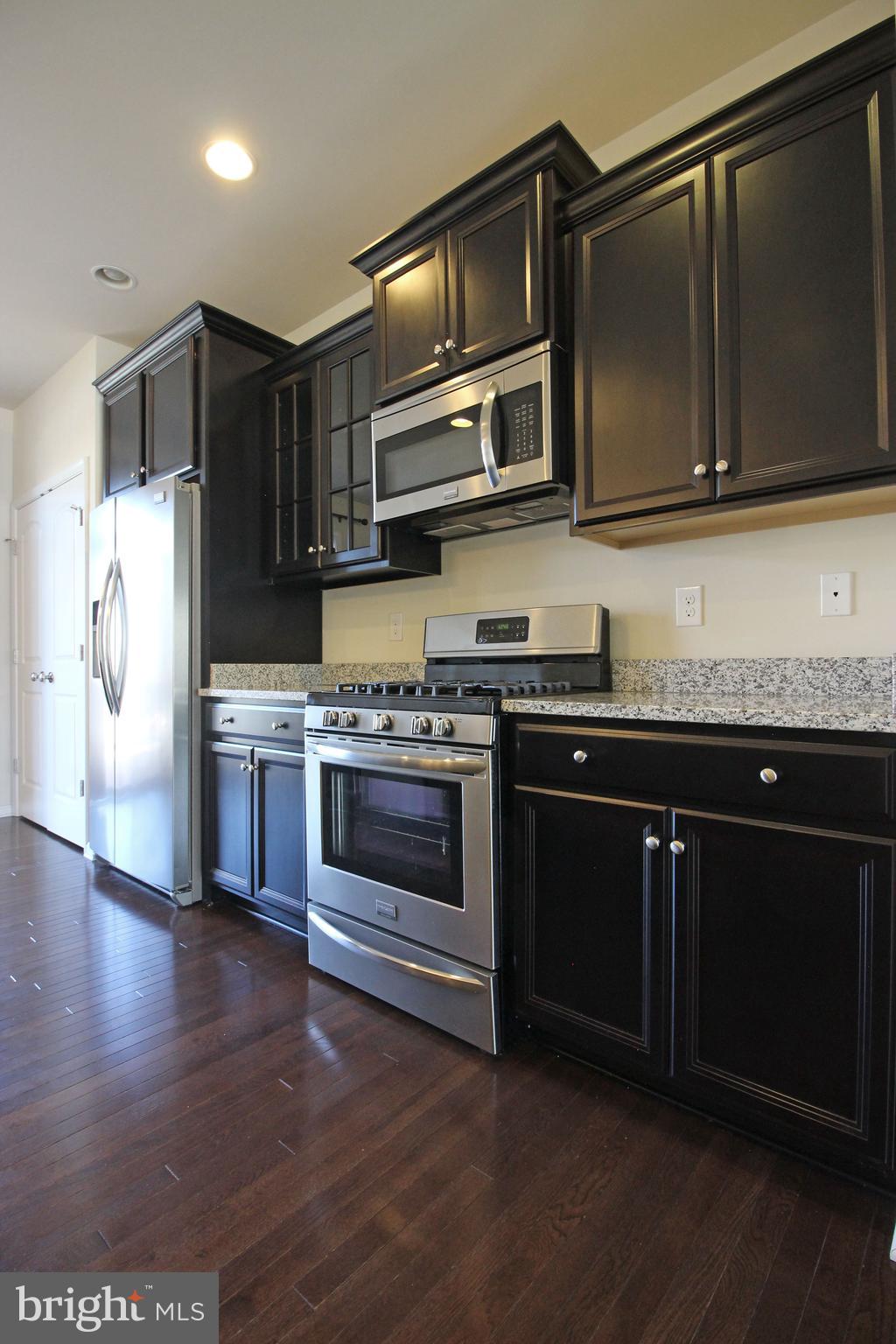4720 Cambria Road Frederick, MD 21703 - Photo 9 of 41 a kitchen with stainless steel appliances granite countertop a stove and a microwave