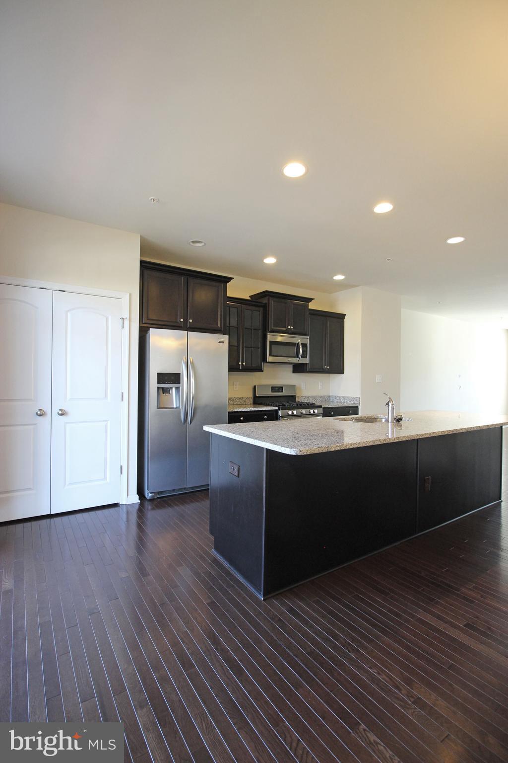 4720 Cambria Road Frederick, MD 21703 - Photo 10 of 41 a large kitchen with wooden floors and stainless steel appliances