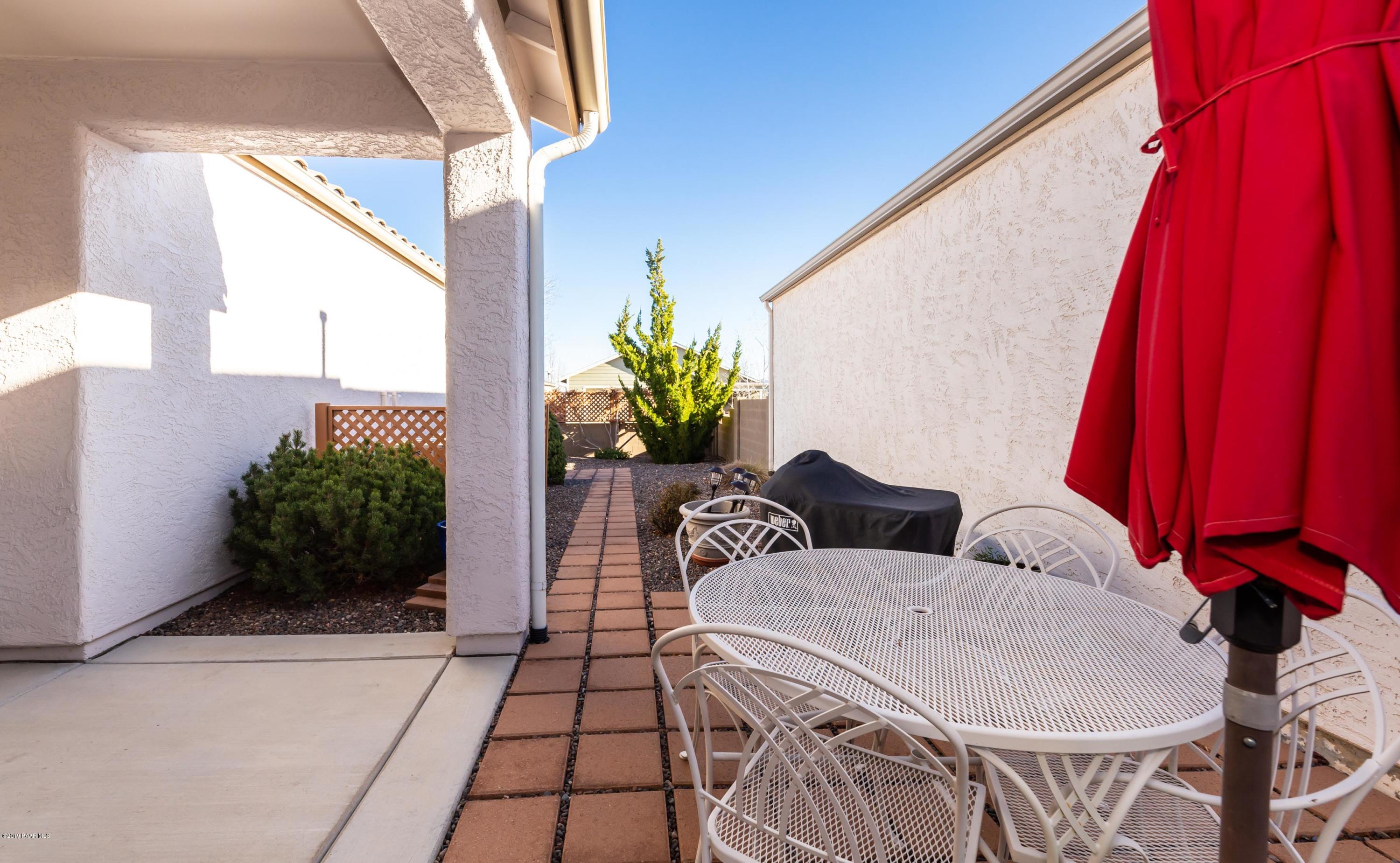 7258 Woolsey Ranch Road Prescott Valley, AZ 86314 - Photo 16 of 28 a balcony with table and chairs