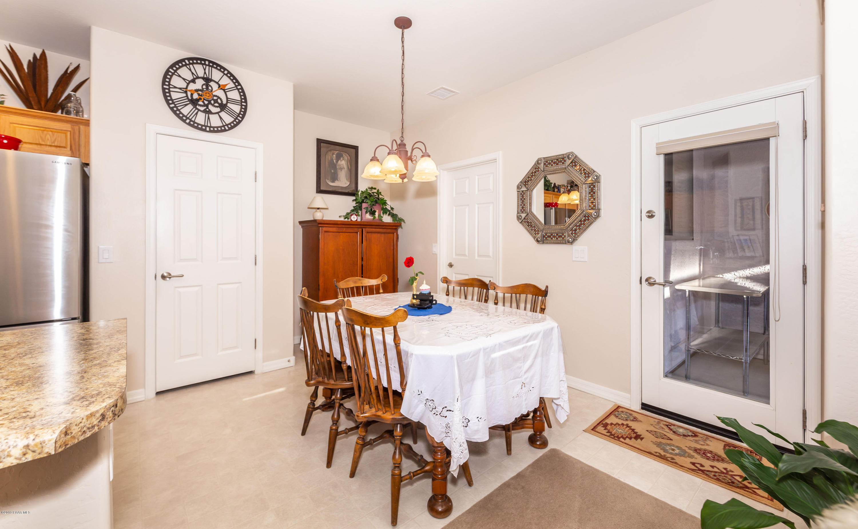 7258 Woolsey Ranch Road Prescott Valley, AZ 86314 - Photo 6 of 28 a bedroom with a bed a mirror a clock and a window