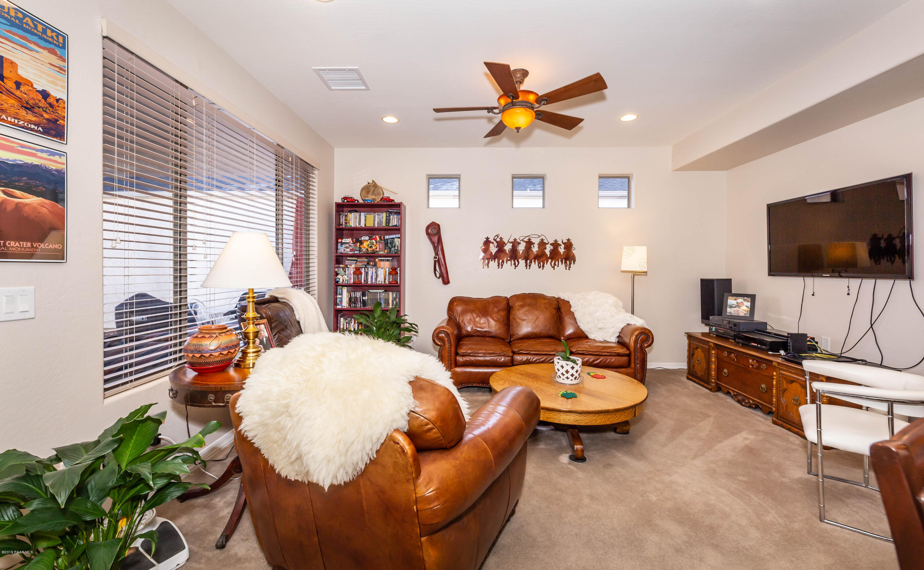 7258 Woolsey Ranch Road Prescott Valley, AZ 86314 - Photo 8 of 28 a living room with furniture and a flat screen tv