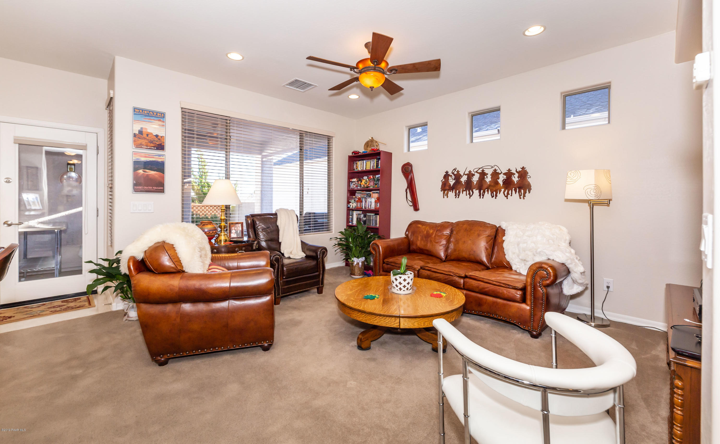 7258 Woolsey Ranch Road Prescott Valley, AZ 86314 - Photo 9 of 28 a living room with furniture and a large window