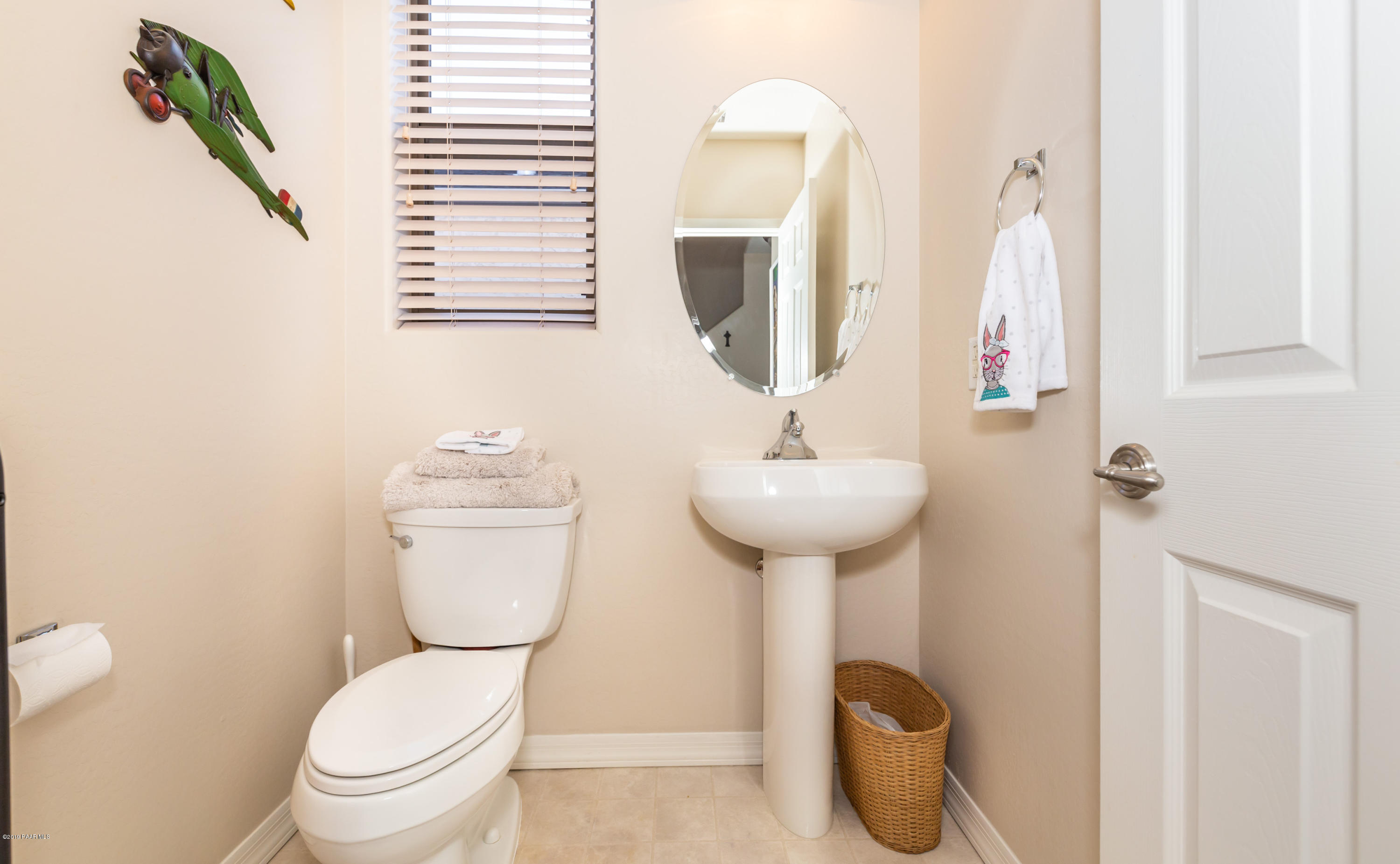 7258 Woolsey Ranch Road Prescott Valley, AZ 86314 - Photo 10 of 28 a bathroom with a toilet sink and mirror