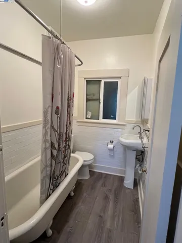 a bathroom with a tub sink and mirror