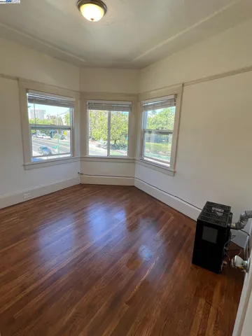 a view of a room with wooden floor and windows