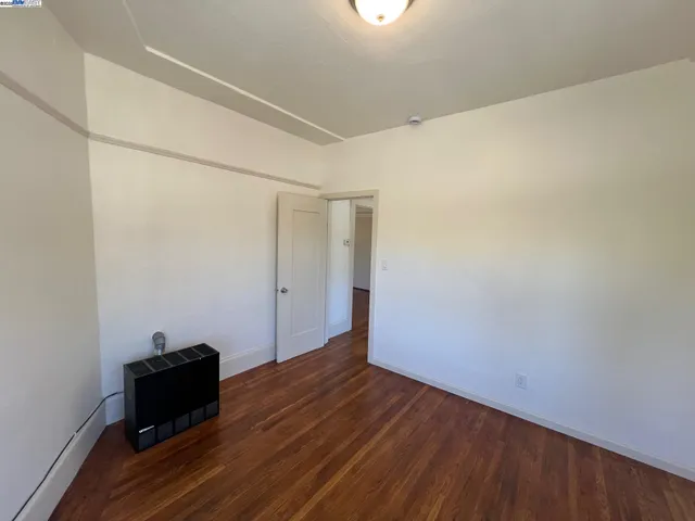 an empty room with wooden floor