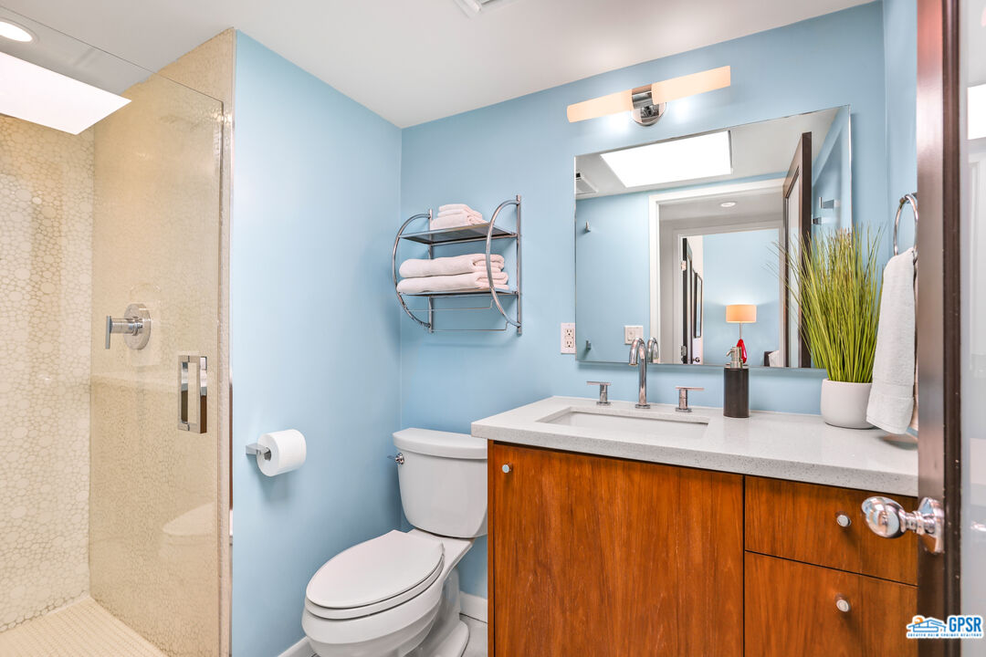2108 George Drive Palm Springs, CA 92262 - Photo 14 of 33 a bathroom with a granite countertop sink and a mirror