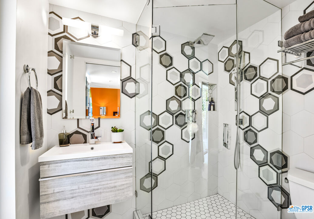 2108 George Drive Palm Springs, CA 92262 - Photo 16 of 33 a bathroom with a sink and mirror