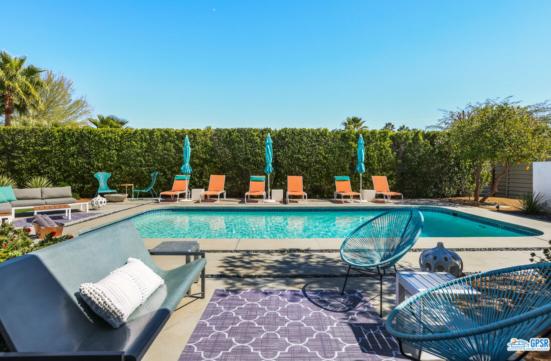 2108 George Drive Palm Springs, CA 92262 - Photo 17 of 33 a view of a swimming pool with lounge chairs