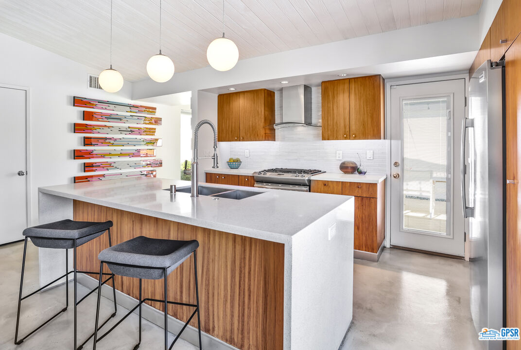 2108 George Drive Palm Springs, CA 92262 - Photo 5 of 33 a kitchen with a sink cabinets and wooden floor