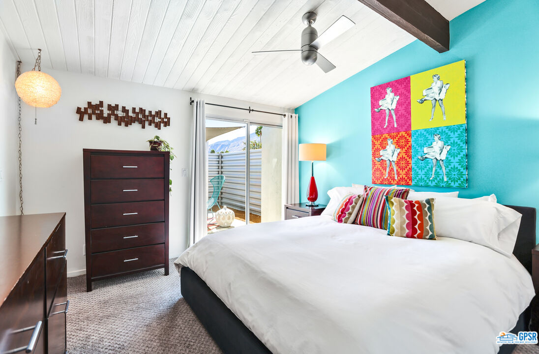 2108 George Drive Palm Springs, CA 92262 - Photo 10 of 33 a bedroom with a bed a dresser and paintings on the wall