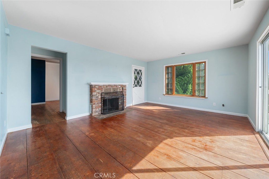 379 Harvey Street Cambria, CA 93428 - Photo 11 of 52 an empty room with windows and fireplace