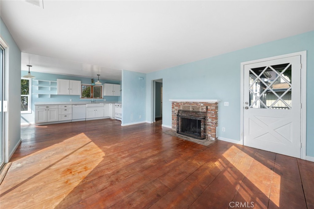 379 Harvey Street Cambria, CA 93428 - Photo 12 of 52 a view of kitchen with granite countertop fireplace and wooden floor