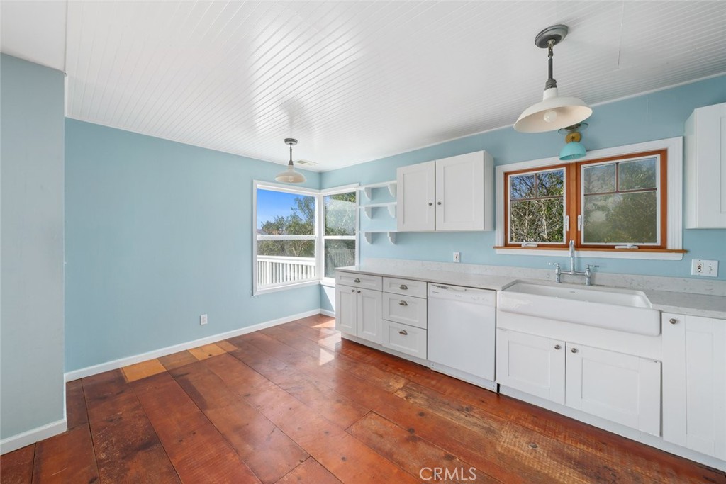 379 Harvey Street Cambria, CA 93428 - Photo 14 of 52 a kitchen with granite countertop white cabinets and window