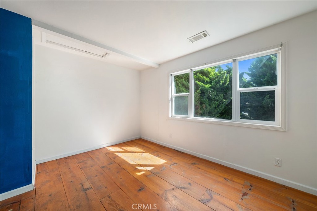 379 Harvey Street Cambria, CA 93428 - Photo 19 of 52 a view of an empty room with wooden floor and a window
