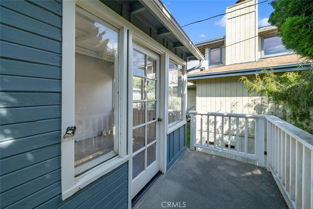 379 Harvey Street Cambria, CA 93428 - Photo 37 of 52 a view of a porch with wooden floor and floor to ceiling window