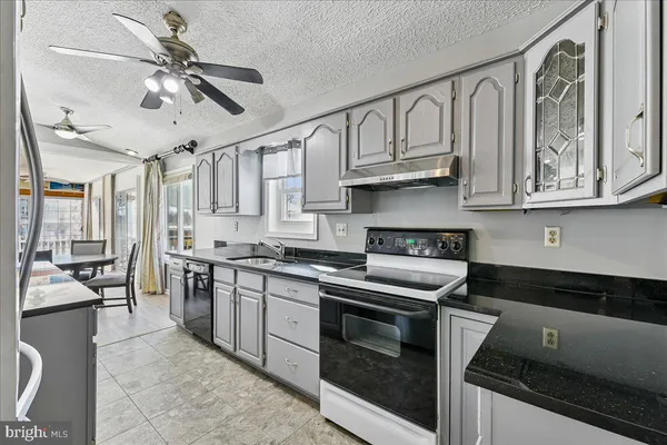 a kitchen with stainless steel appliances granite countertop a stove and cabinets