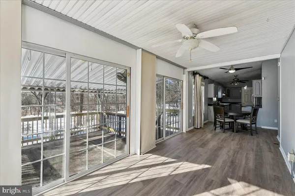 a view of a bedroom with furniture window and wooden floor
