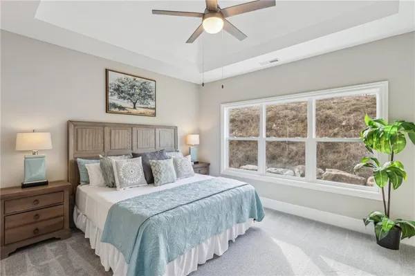 a bedroom with a large bed and a potted plant