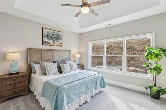 a bedroom with a large bed and a potted plant