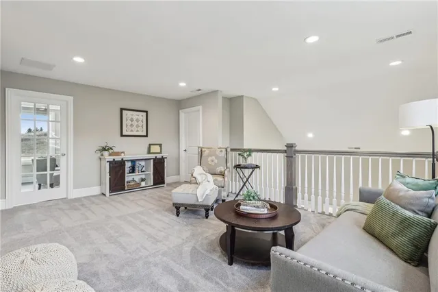 a living room with furniture and white walls