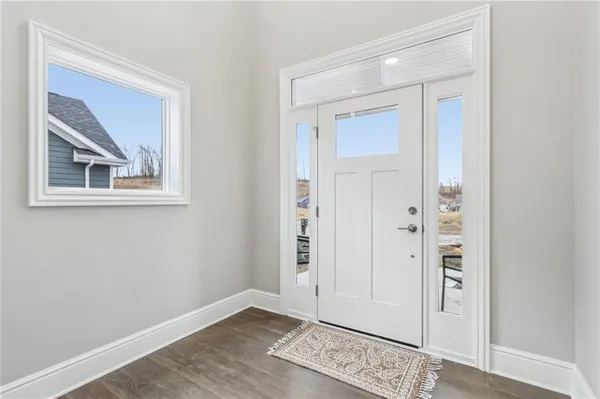 an empty room with wooden floor and mirror