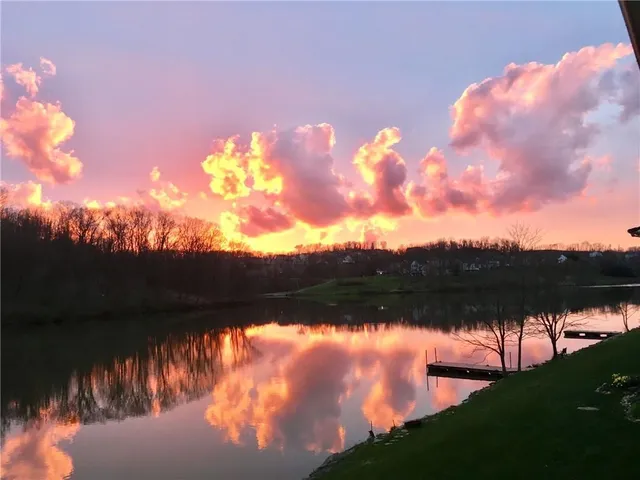 a sunset view with a lake