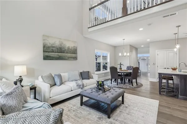 a living room with furniture potted plant and a table