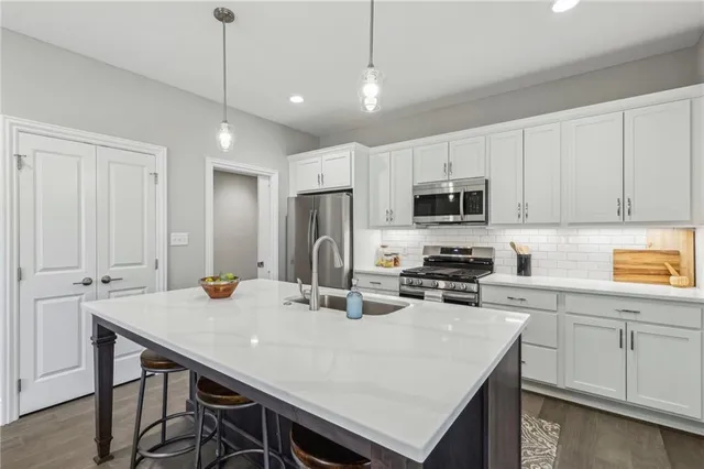 a kitchen with kitchen island a table and chairs