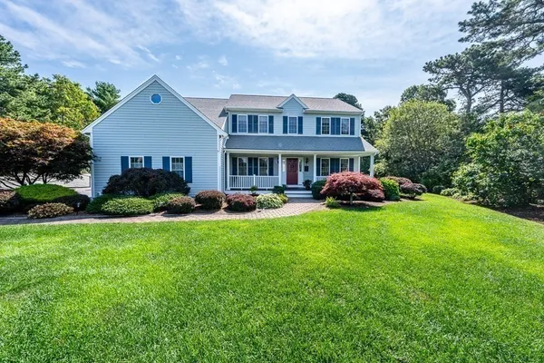 a front view of house with yard and green space