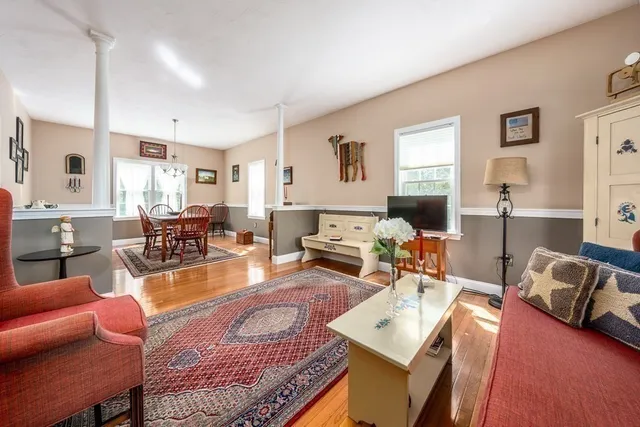 a living room with furniture or couch and a wooden floor