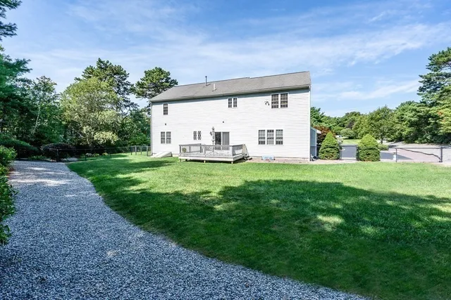 a view of a house with a yard and sitting area