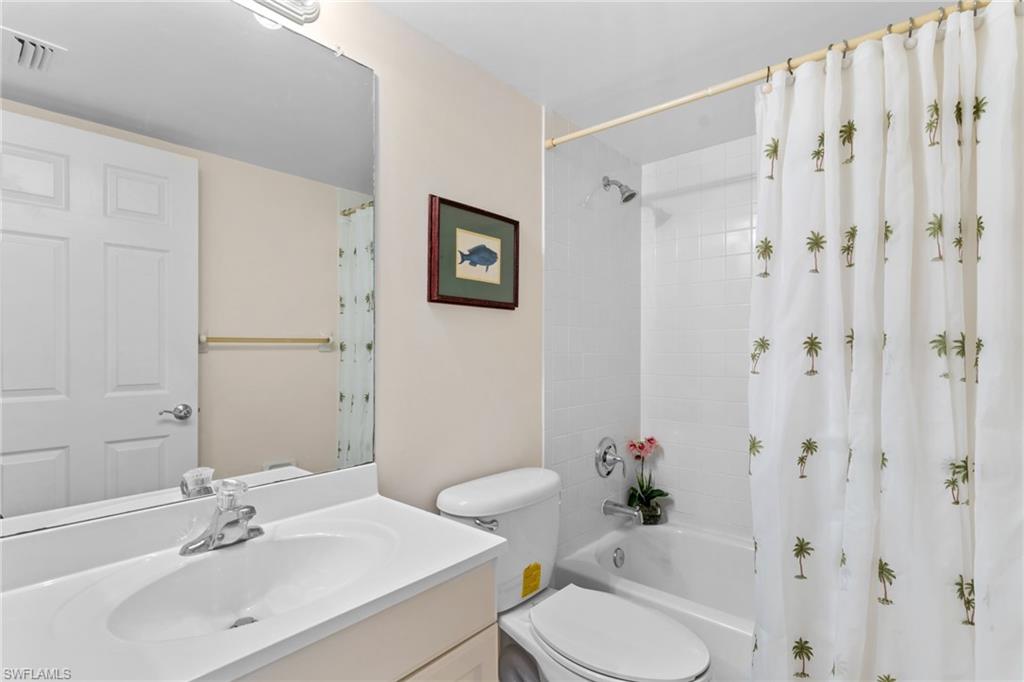 776 Landover Circle, Unit 104 Naples, FL 34104 - Photo 16 of 25 a bathroom with a sink toilet and shower